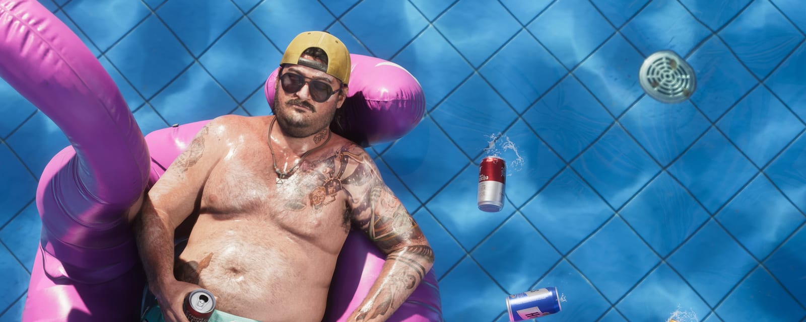A Leonida pool with a pink flamingo float and toppled cans, from Rockstar's official "Only in Leonida" campaign.